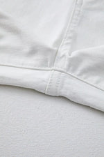 Close-up of white fabric with a focus on texture and stitching