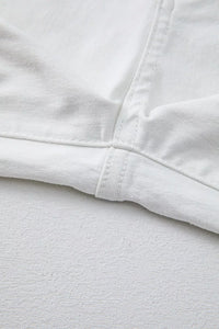 Close-up of white fabric with a focus on texture and stitching
