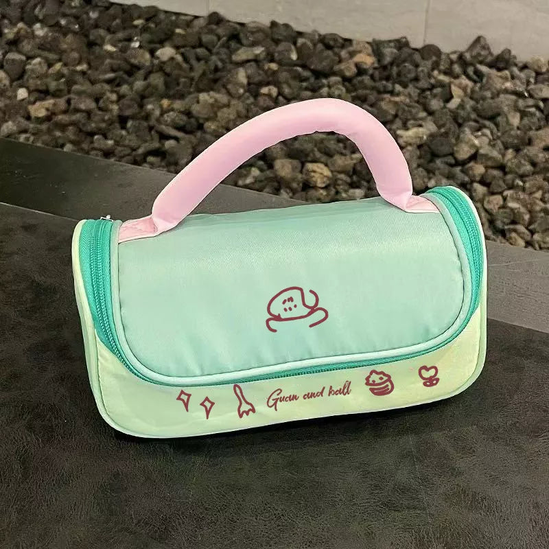 Mint green pouch with pink handle on a dark surface