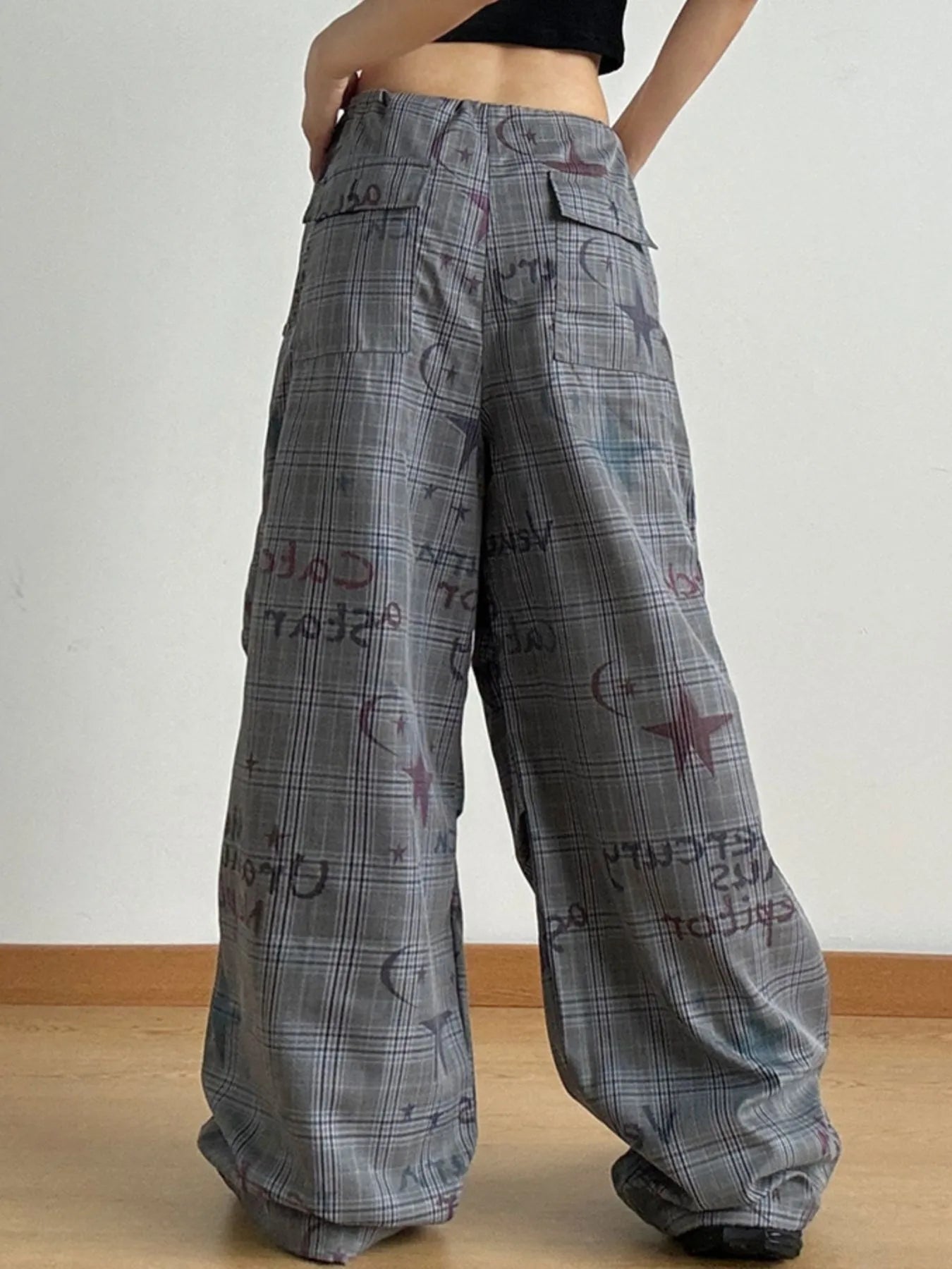 Plaid pants with text and graphics on a plain background
