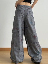 Plaid pants with text and graphics on a plain background