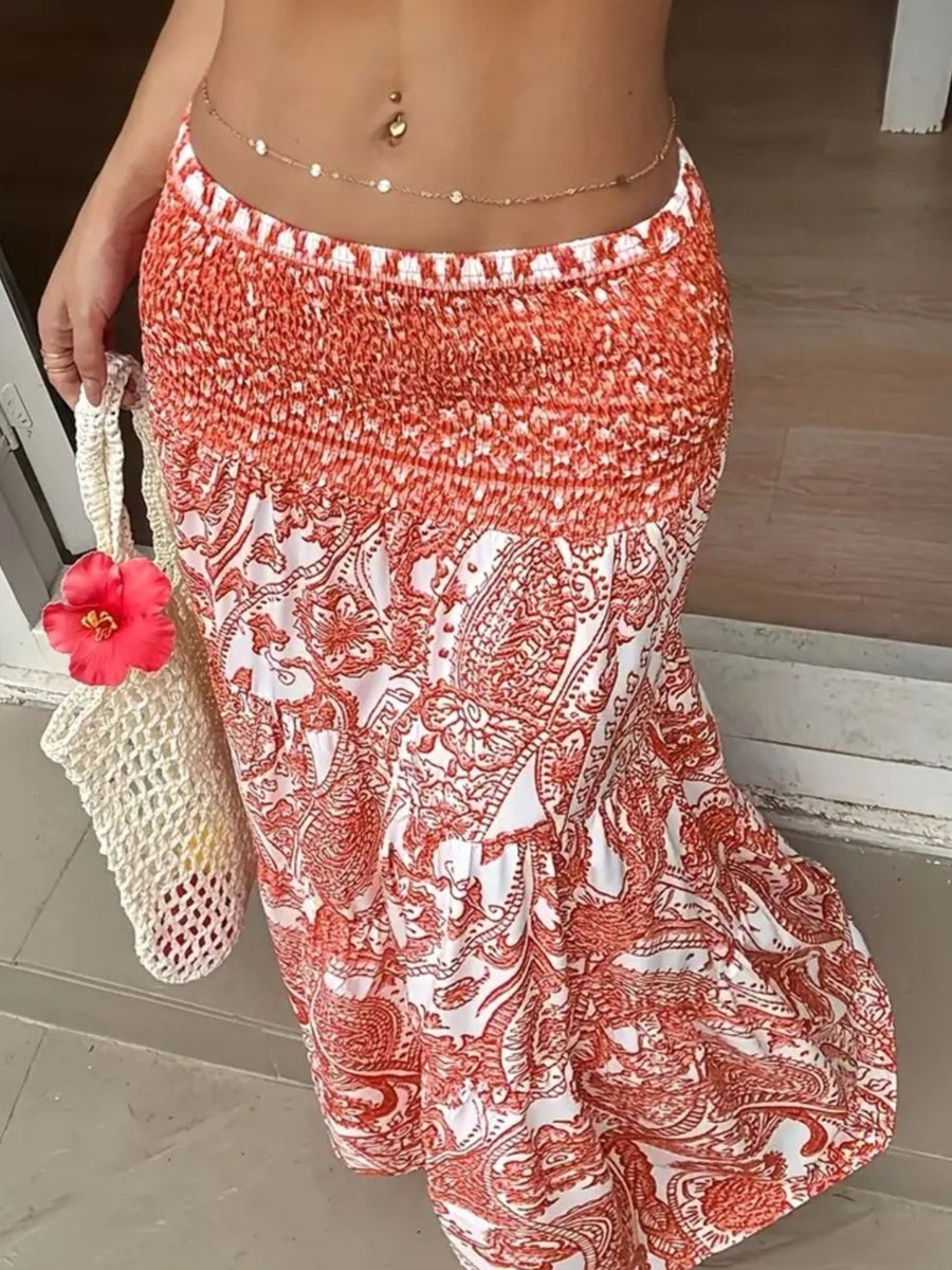 Person wearing a red and white patterned skirt with a pink flower and white bag.