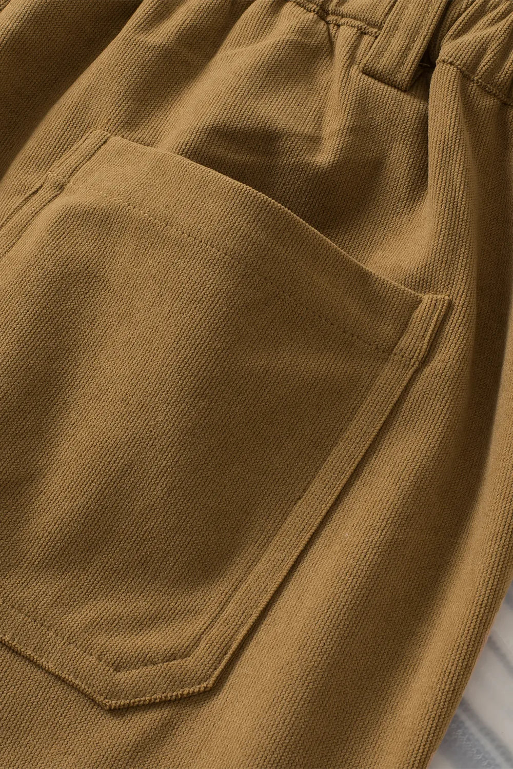 Close-up of brown pants with a pocket