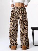 Leopard print pants worn with a white crop top on a white background