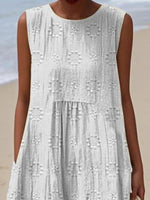 White lace dress worn by a person on a beach