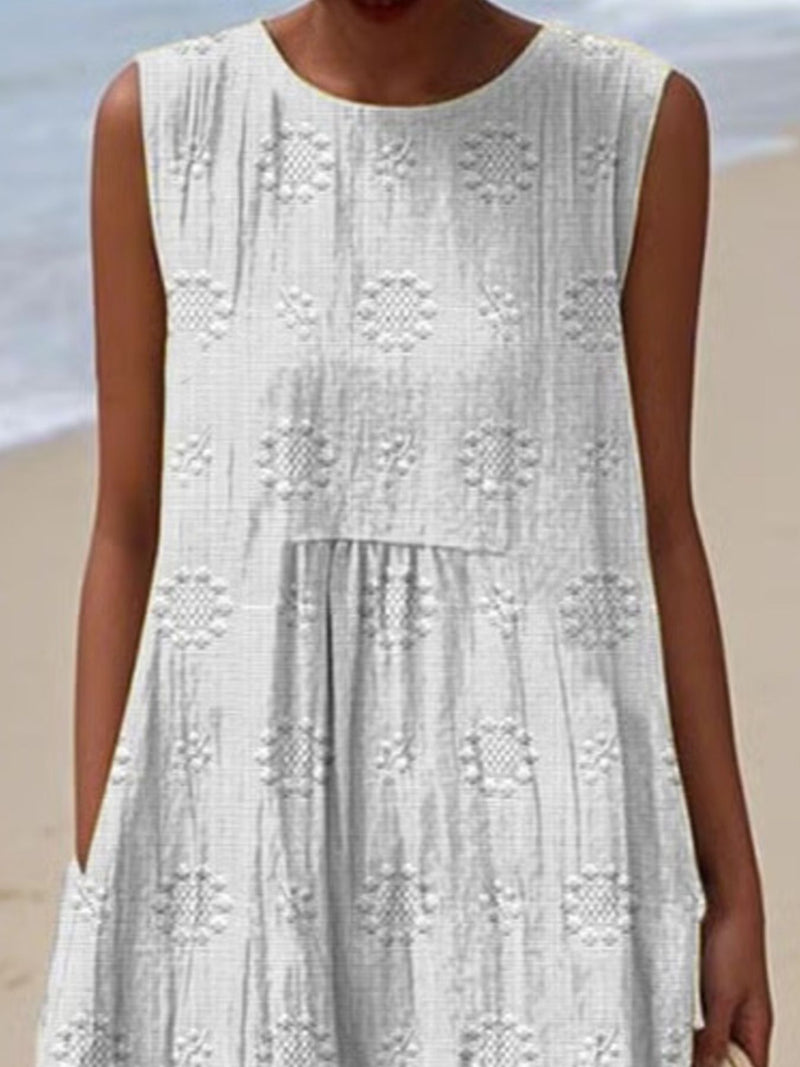 White lace dress worn by a person on a beach