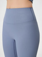 Blue ribbed leggings on a plain background