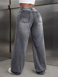 Person wearing high-waisted gray jeans against a neutral background