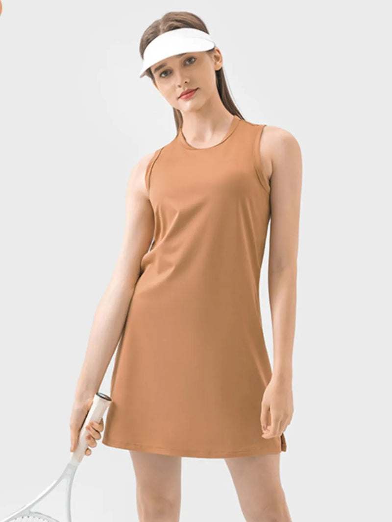 Woman in a brown dress holding a tennis racket on a white background