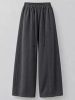 Dark gray wide-leg sweatpants with an elastic drawstring waist, shown against a neutral light gray background.