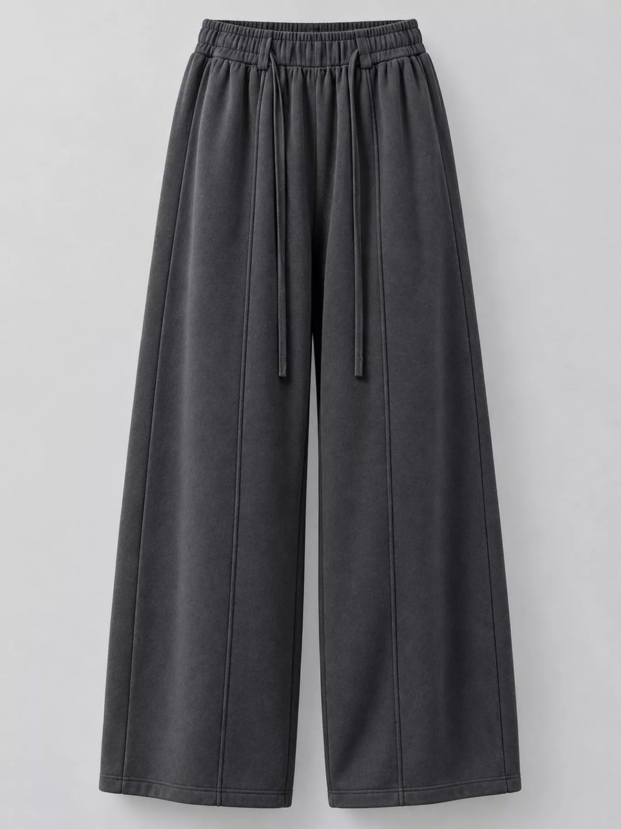 Dark gray wide-leg sweatpants with an elastic drawstring waist, shown against a neutral light gray background.