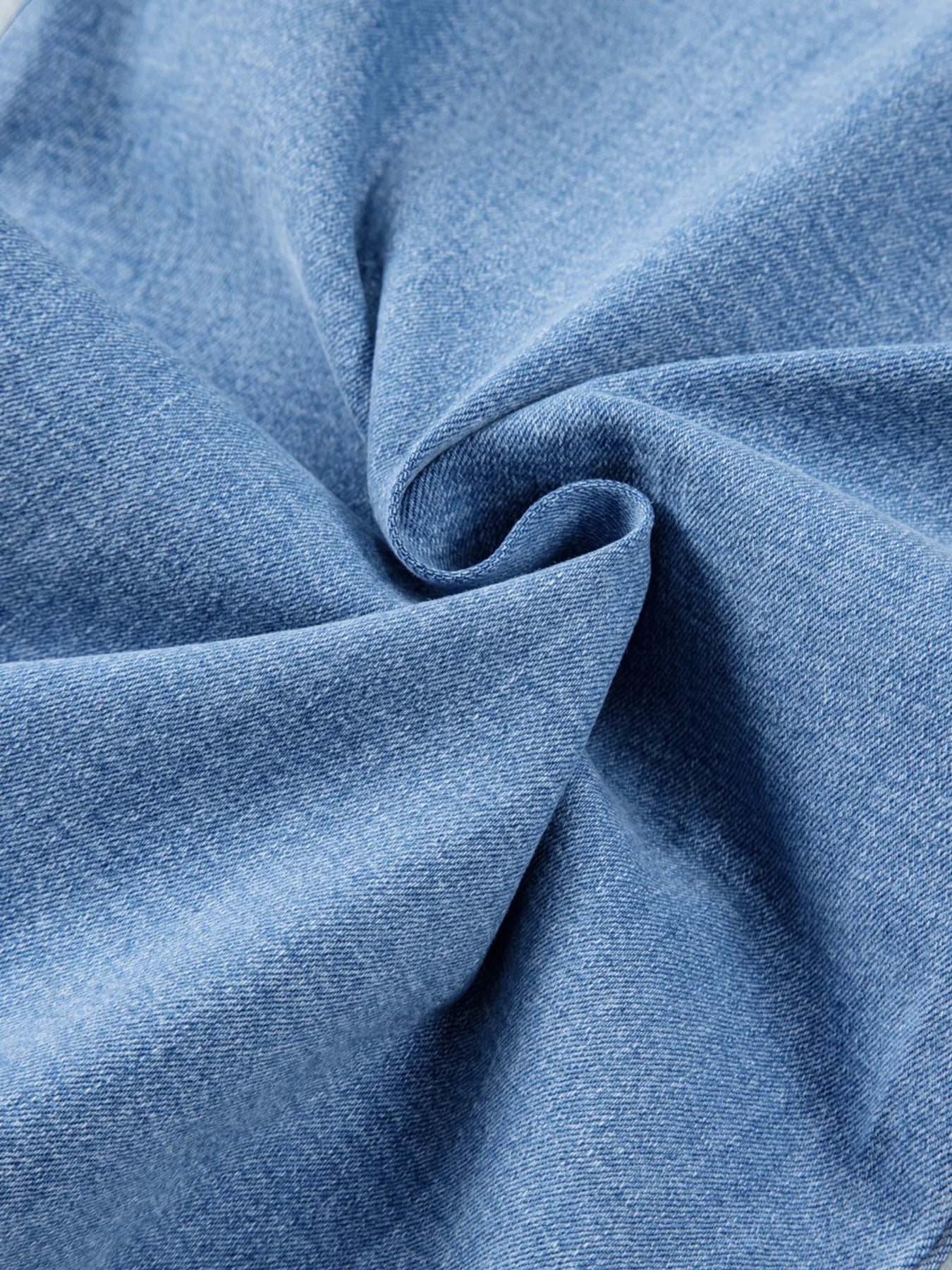 Close-up of blue denim fabric with folds