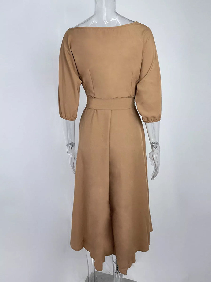 Brown dress on a mannequin against a white background