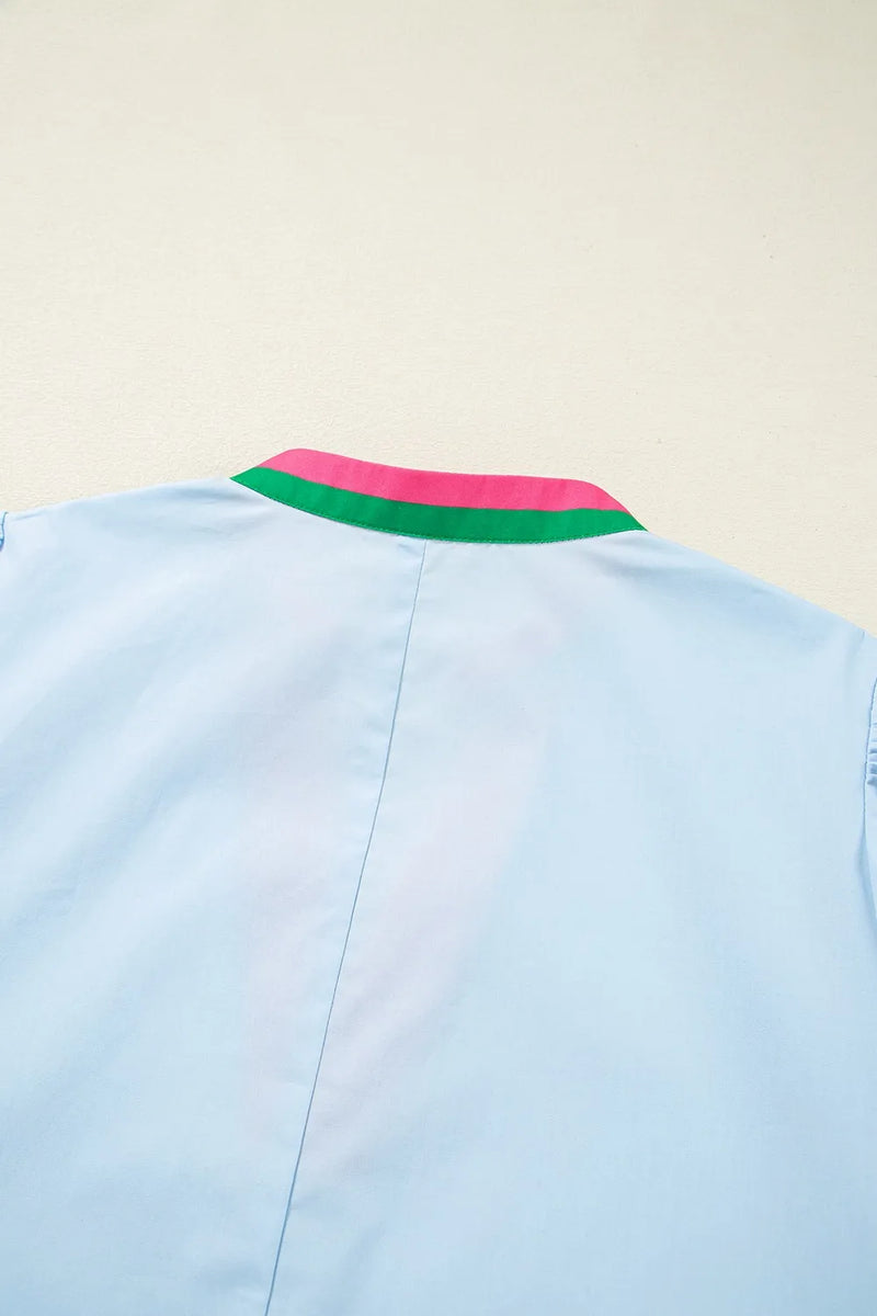 Light blue shirt with a colorful collar on a beige background