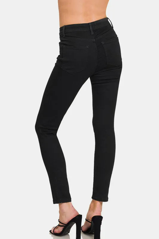 Black pants worn by a person on a white background