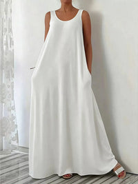 Woman wearing a white sleeveless dress against a neutral background