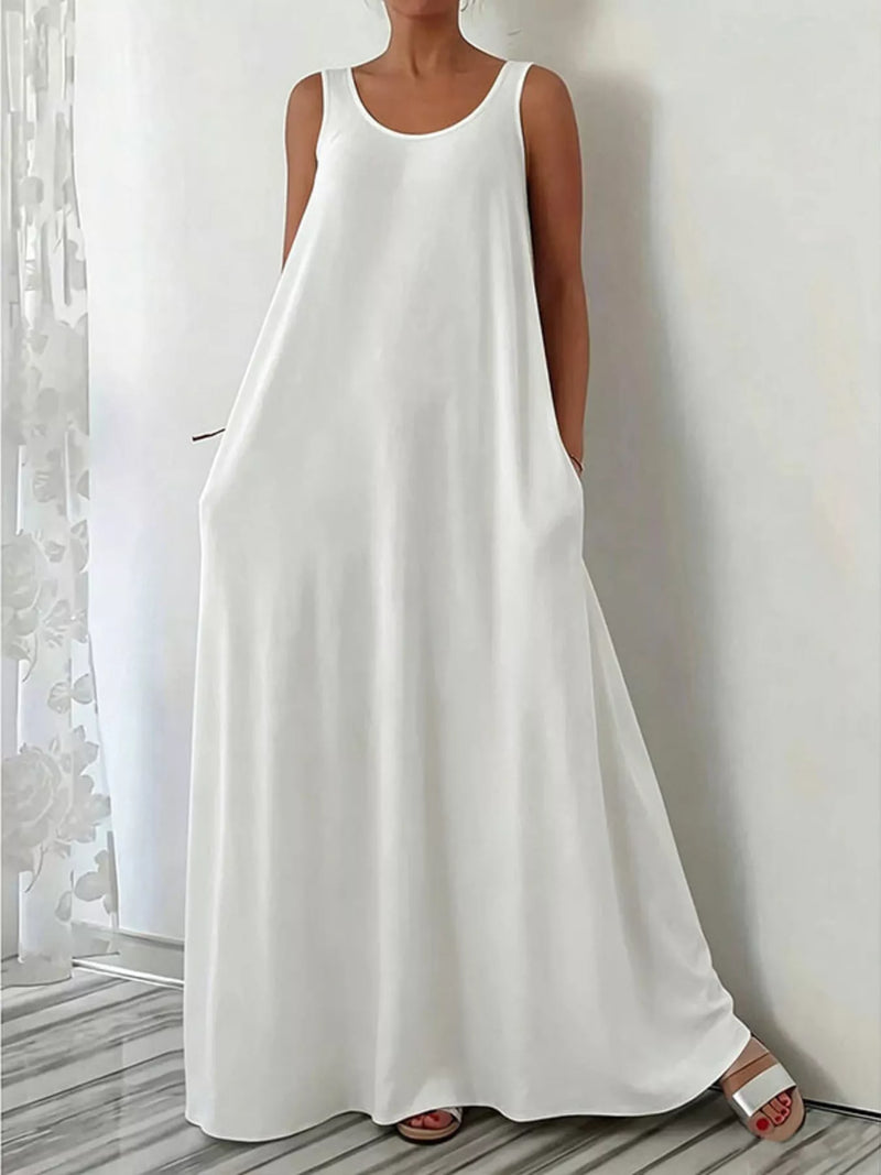 Woman wearing a white sleeveless dress against a neutral background