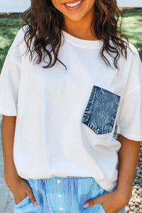 Person wearing a white t-shirt with a denim pocket and blue striped pants.