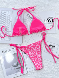 Pink bikini set with leopard print bottom on a magazine background