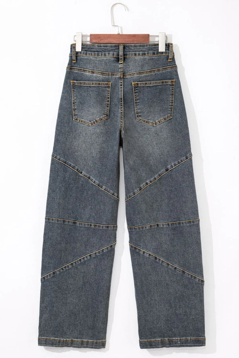 Blue jeans on a hanger against a white background