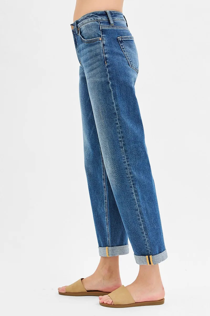 Blue jeans worn by a person on a white background