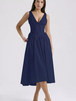 Woman wearing a navy blue dress on a white background