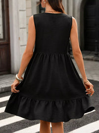 Person wearing a black dress on a city street