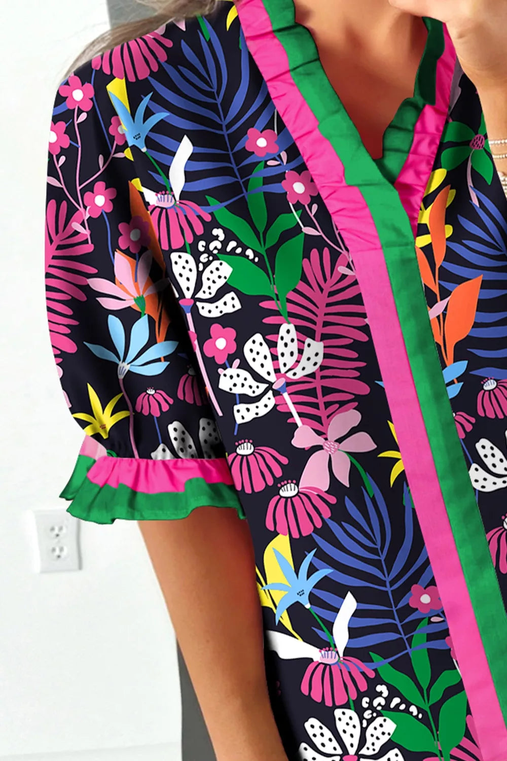 Colorful floral-patterned garment with a white wall background