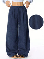 Navy blue wide-leg pants with a close-up of the fabric texture on a white background.