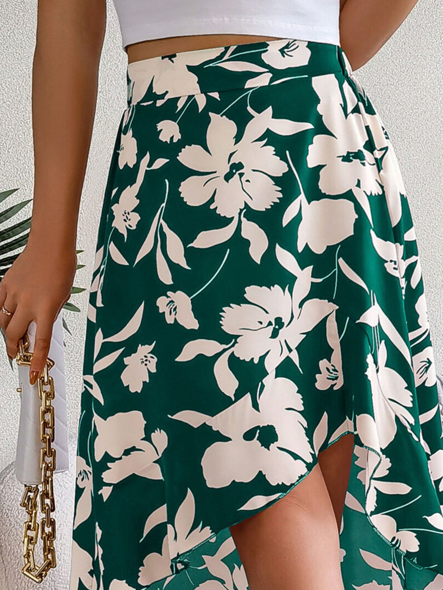 Green floral skirt worn by a person on a light gray background