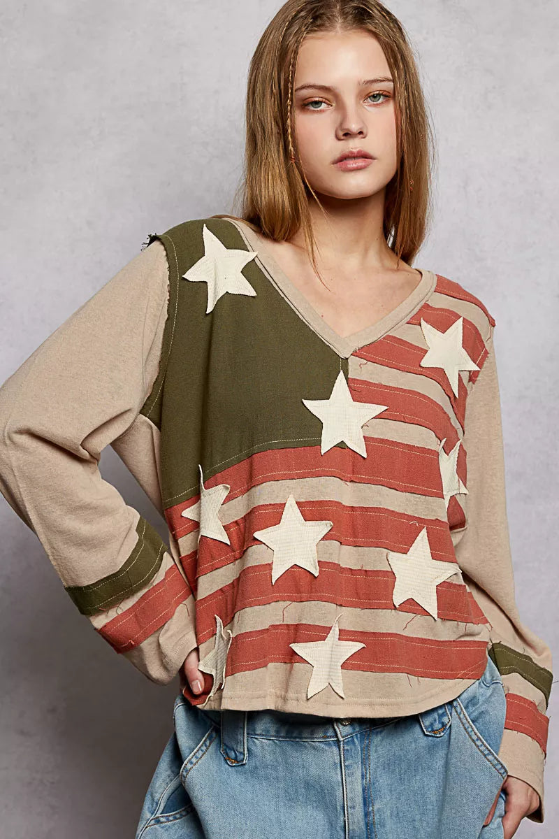 Woman wearing a sweater with American flag design and stars