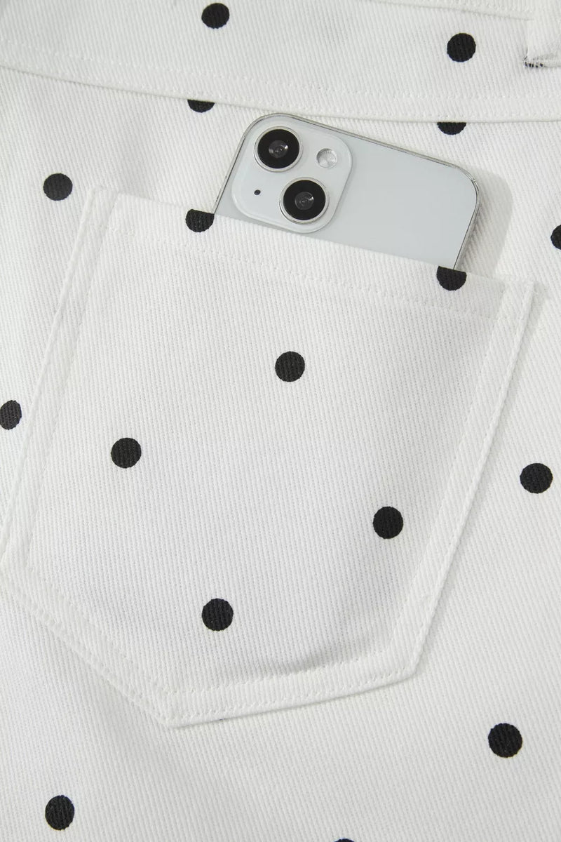 White polka dot jeans with a smartphone in the pocket
