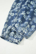 Blue floral-patterned jeans on a white background