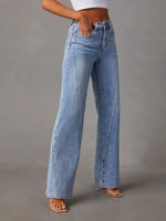 Light blue jeans worn by a person on a gray background