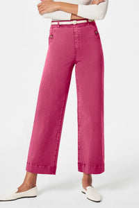 Person wearing bright pink pants on a white background