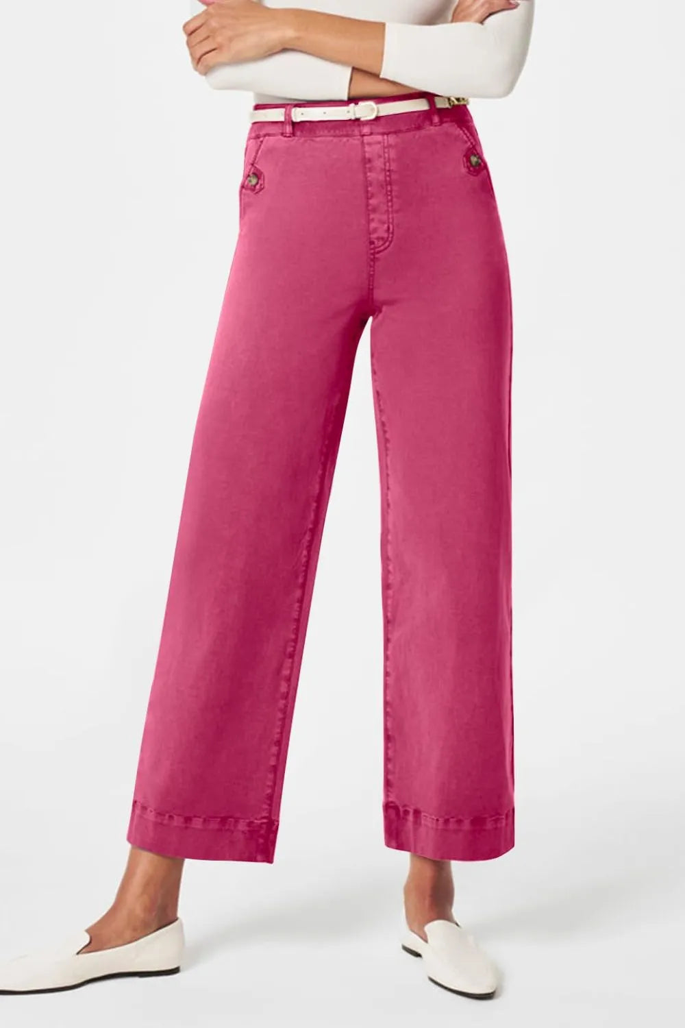 Person wearing bright pink pants on a white background