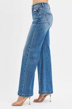 Blue jeans worn by a person on a white background