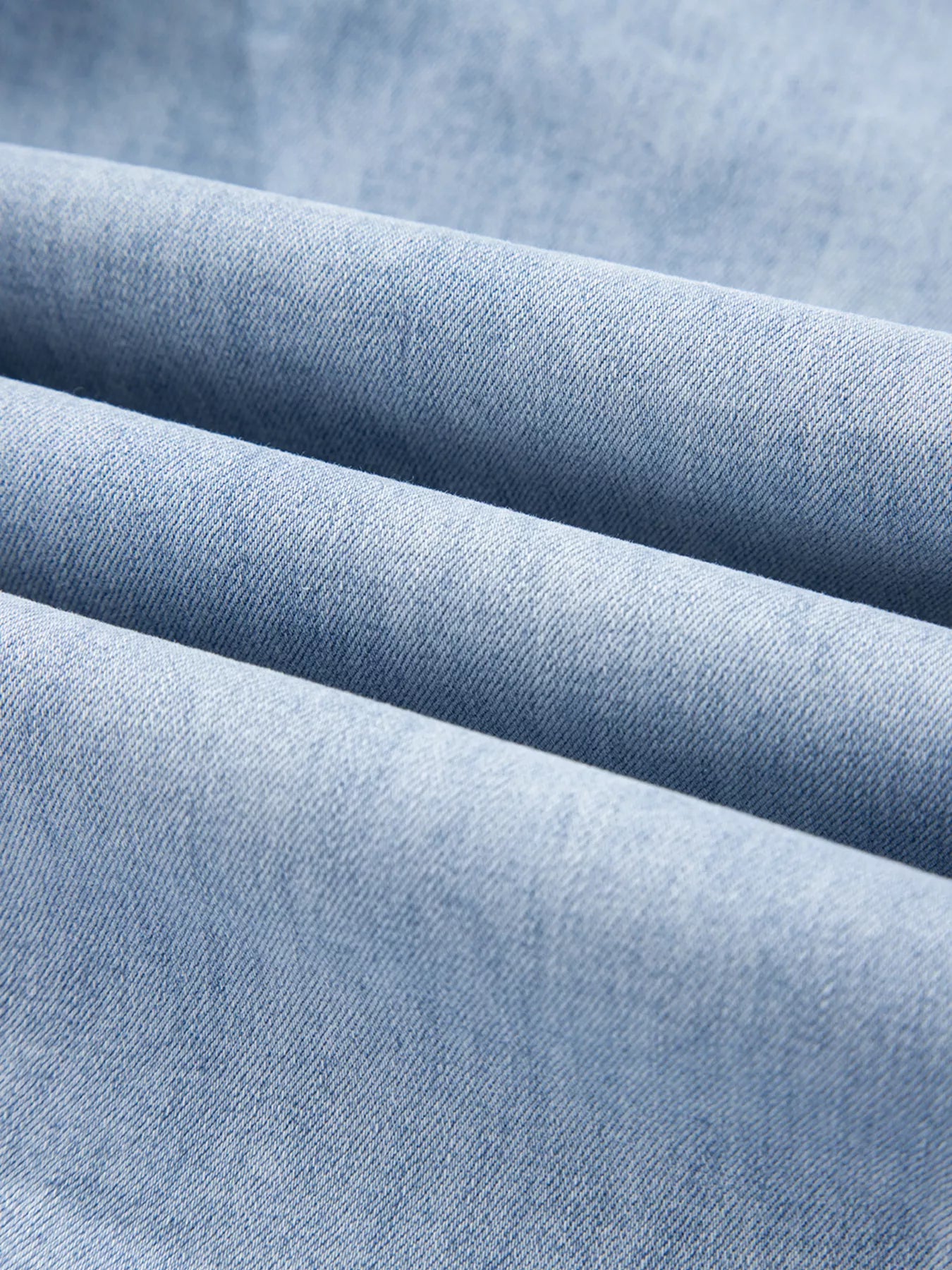 Close-up of blue denim fabric with folds