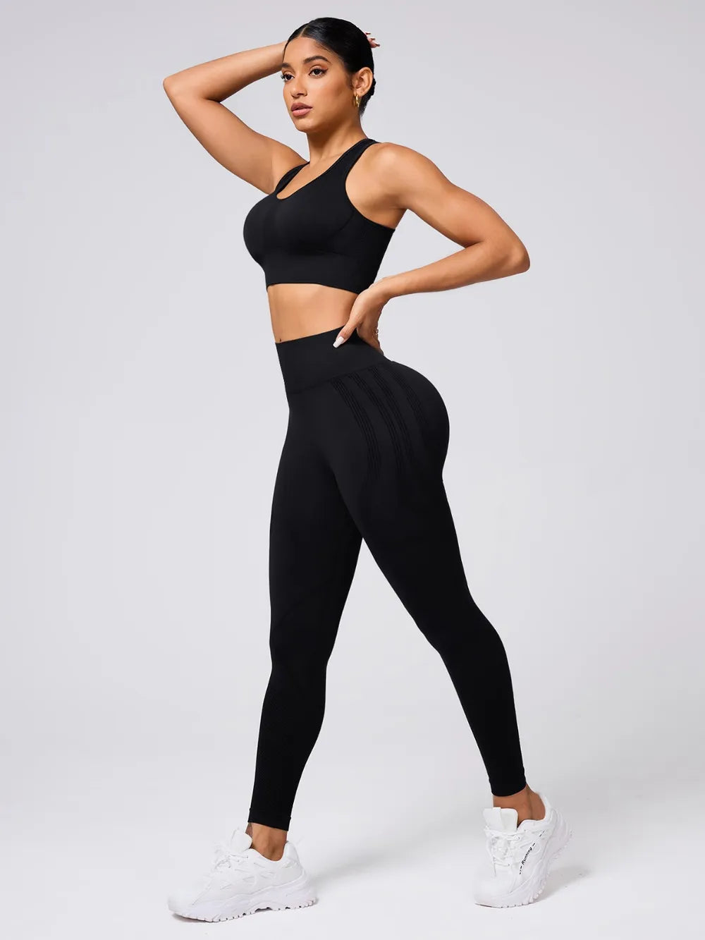 Person wearing a black athletic outfit on a white background