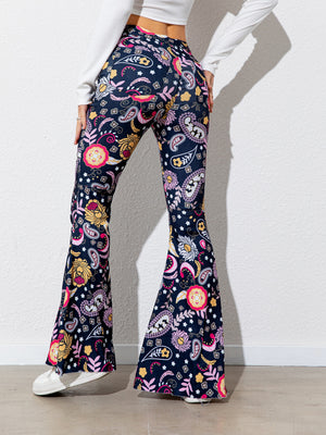 Flared pants with colorful pattern worn by a person on a plain background