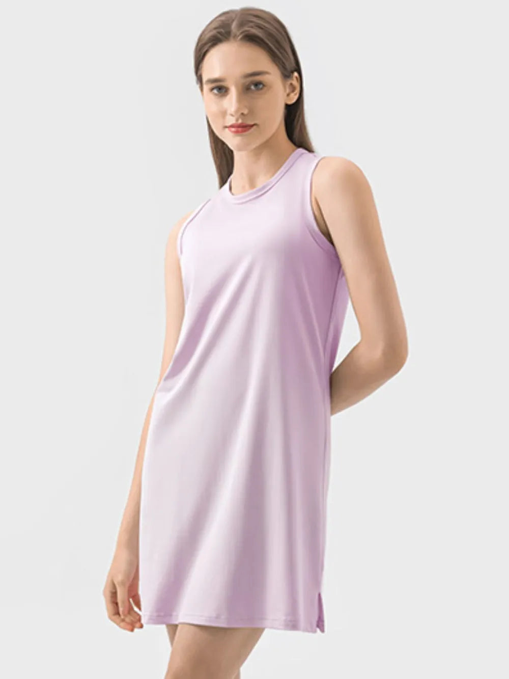 Woman wearing a light purple sleeveless dress on a white background