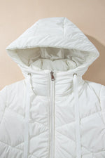 White quilted jacket with a hood on a beige background