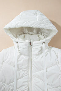 White quilted jacket with a hood on a beige background