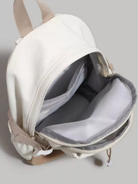 White backpack with beige straps on a light gray background