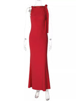 Red evening gown on a white mannequin against a white background