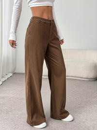 Brown wide-leg pants worn by a person indoors.