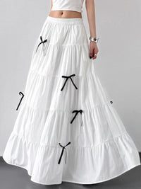 White long skirt with black bows on a gray background