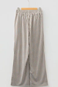 Striped pants on a hanger against a white background