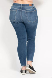 Blue jeans worn by a person on a white background