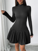 Black long-sleeve dress with a ruffled skirt on a white background